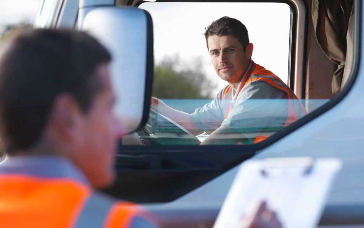 Truck driver at safety inspection stop
